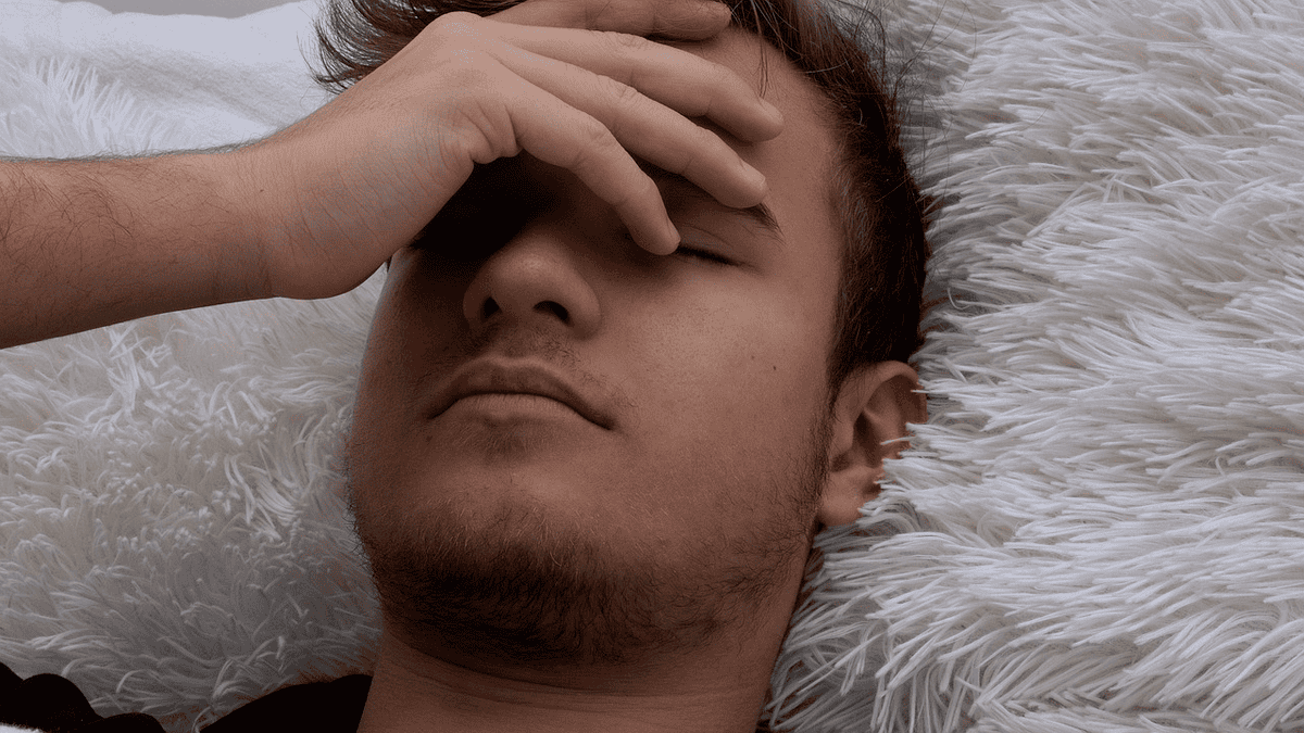 Boy lying sick, feeling ill. How to lose 30 pounds in 30 days.